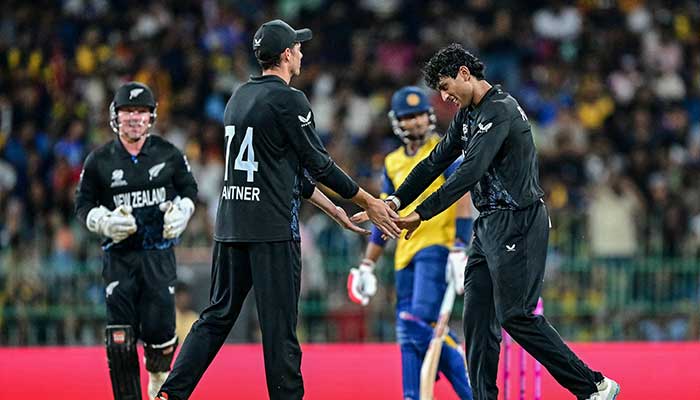 New Zealands Rachin Ravindra (R) celebrates with captain Mitchell Santner (2L) after taking the wicket of Sri Lankas captain Dasun Shanaka during the 2026 ICC Mens T20 Cricket World Cup Super Eights match between Sri Lanka and New Zealand at the R Premadasa Stadium in Colombo on February 25, 2026. — AFP
