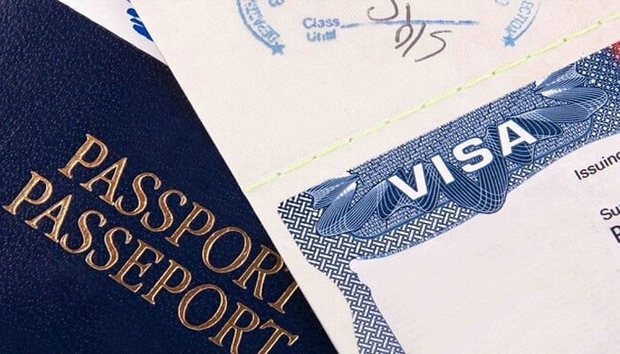 This representational image shows visa and passport. —Reuters/File