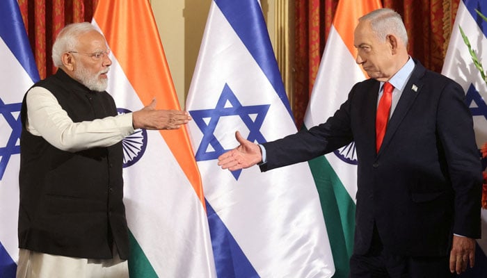 Israels Prime Minister Benjamin Netanyahu and Indias Prime Minister Narendra Modi reach to shake hands as they attend a press conference in Jerusalem on February 26, 2026. — Reuters