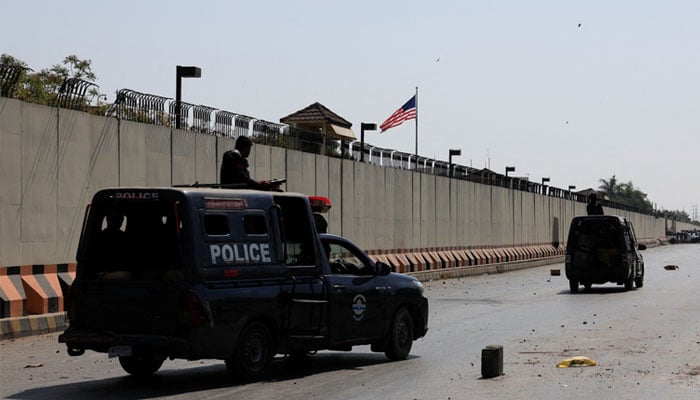 Police vehicles patrol after a protest outside the US Consulate General, following news of US and Israeli strikes on Iran that martyred Irans Supreme Leader Ayatollah Ali Khamenei, in Karachi on March 1, 2026. — Reuters