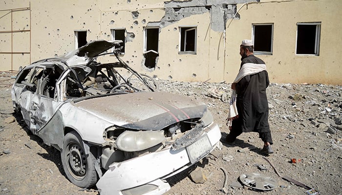 Taliban security personnel stand at the site of a Pakistani air strike in the Takhta Pul district of Kandahar on February 28, 2026. — AFP