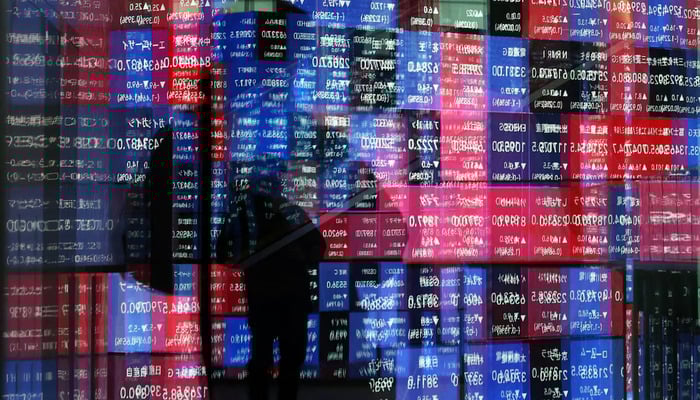 A stock quotation board is reflected on window glasses at a building in Tokyo, Japan December 11, 2025. — Reuters