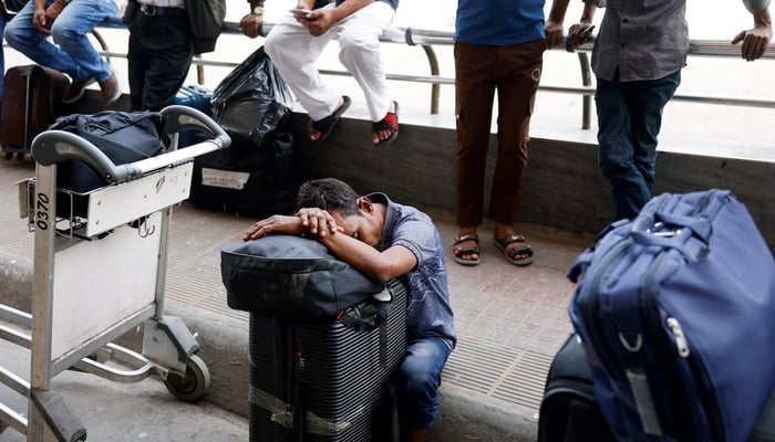 Stranded passengers wait at Hazrat Shahjalal International Airport after flights to Dubai and Bahrain were cancelled, after Iranian strikes, following strikes on Iran launched by the United States and Israel, in Dhaka, Bangladesh, March 1, 2026. — Reuters