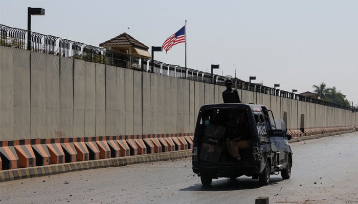 A police vehicle patrols outside the US Consulate General in Karachi on March 1, 2026. — Reuters