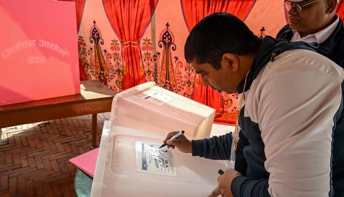 Polling officials prepare ballot boxes at a booth on the eve of Nepals parliamentary elections in Kathmandu on March 4, 2026. — AFP