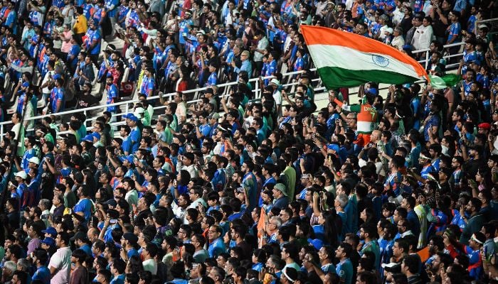 Fans wave Indias national flag before the start of the 2026 ICC Men´s T20 Cricket World Cup Super Eights match between India and West Indies at the Eden Gardens in Kolkata on March 1, 2026. — AFP
