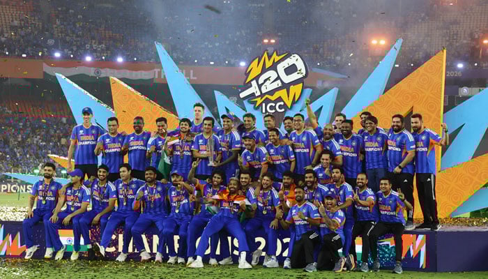 Indian players celebrate on the podium with the trophy after winning the ICC Mens T20 World Cup 2026 after defeating New Zealand in the final. — Reuters