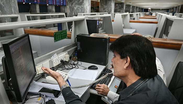 A stockbroker monitors share prices at the Pakistan Stock Exchange (PSX) in Karachi on March 2, 2026. — AFP