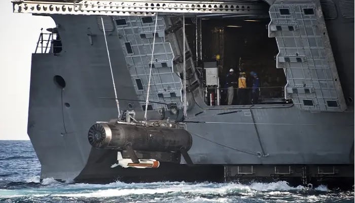 The Remote Minehunting System and an AN/AQS-20 mine-hunting sonar are brought aboard the littoral combat ship USS Independence during testing of a mine-warfare mission module. — US Navy