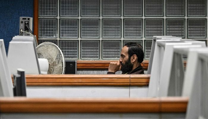 A stockbroker monitors share prices on a computer at the Pakistan Stock Exchange (PSX) in Karachi on March 9, 2026. — AFP