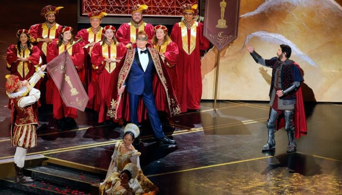 Host Conan OBrien performs during the start of the show. — Reuters