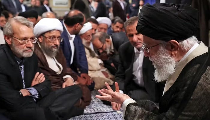 Iran’s Supreme Leader Ali Khamenei (right) speaks to top security official Ali Larijani (left) during a high-level meeting in this undated photo.—X@MehrnewsCom