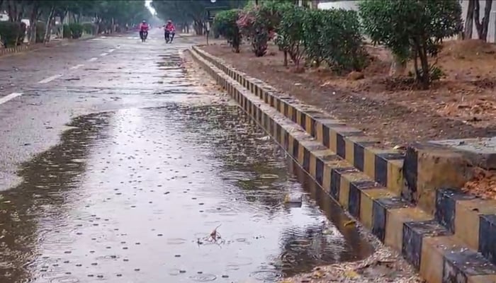 Rainwater forms a puddle on roadside in Karachi after heavy rain on March 19, 2026. — Geo News