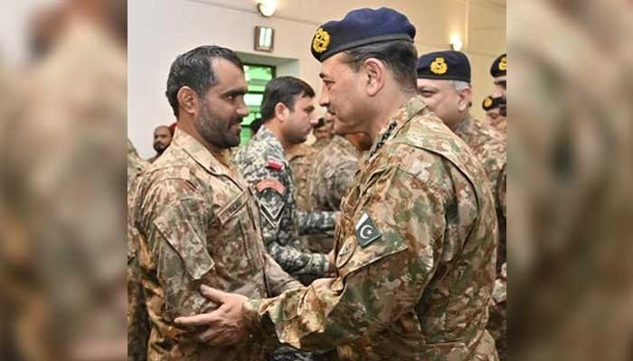 CDF Field Marshal Asim Munir interacts with a soldier on Eid ul Fitr in Kurram, on March 21, 2026. — ISPR