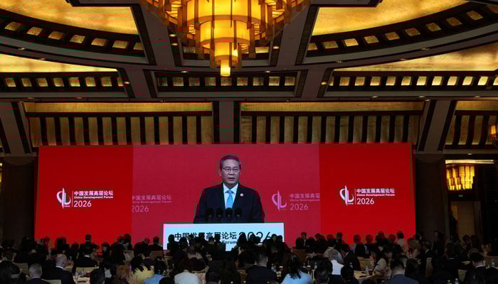 Chinese Premier Li Qiang is seen on a big screen live broadcasting his speech at the opening of the China Development Forum 2026 held at the Diaoyutai State Guesthouse in Beijing, China, March 22, 2026. — Reuters