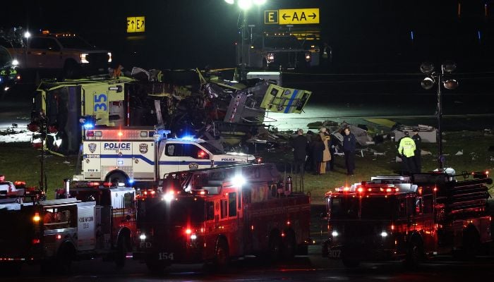 Emergency personnel respond to the Port Authority fire truck that was struck by a landing Air Canada Express plane at LaGuardia Airport in New York, on March 23, 2026. — AFP