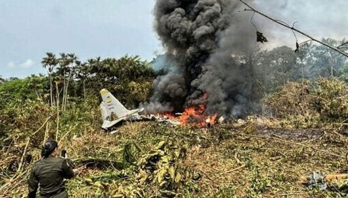 Military personnel clambered over the wreckage of the Hercules transport plane, enveloped in smoke. — AFP/File