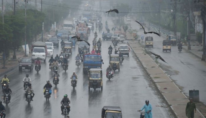 Commuters are passing through a road during the downpour of monsoon in Karachi on August 23, 2025. — Online