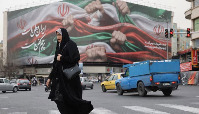 An Iranian woman walks on a street in Tehran, Iran, January 19, 2026. — Reuters