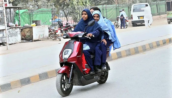 Students on their way to school on a scooty in Sargodhas Satellite Town, on February 17, 2026. — APP