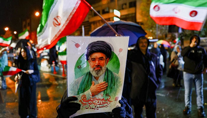 A woman holds a poster depicting Iran’s new Supreme Leader Mojtaba Khamenei during an anti-US and anti-Israeli rally, amid the US-Israeli conflict with Iran, in Tehran, Iran, March 26, 2026. — Reuters