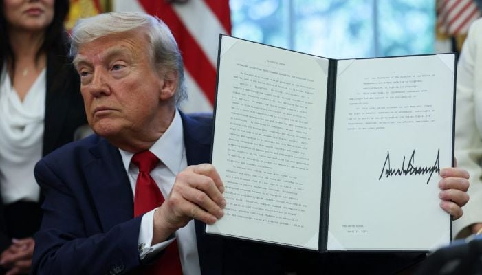 US President Donald Trump holds a signed executive order in the Oval Office at the White House in Washington, DC, US, April 23, 2025. — Reuters