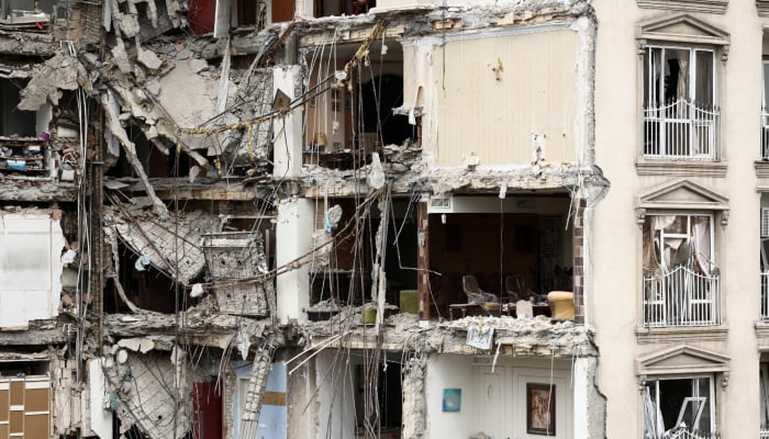 A view of a residential building damaged by a strike, amid the US-Israeli conflict with Iran, in Tehran, Iran, March 23, 2026. — Reuters