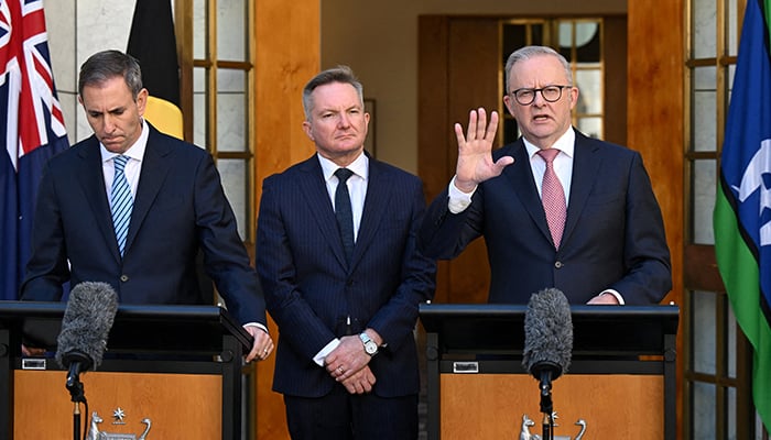 Australian Treasurer Jim Chalmers and Australian Energy Minister Chris Bowen listen as Australian Prime Minister Anthony Albanese speaks to the media during a press conference at Parliament House in Canberra, Australia, 30 March, 2026. — Reuters