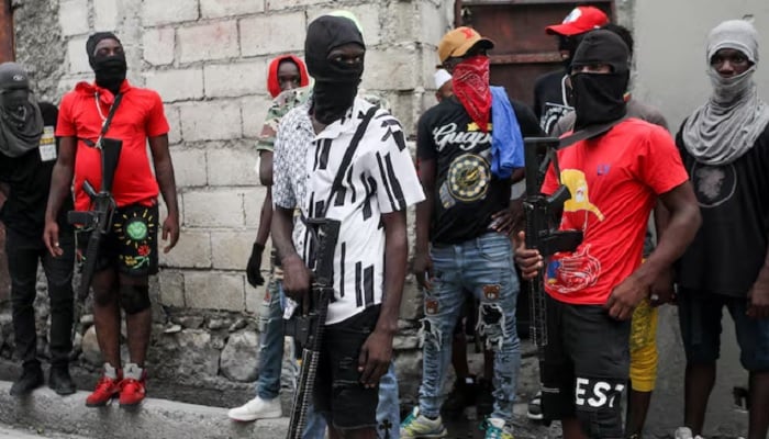 Former police officer Jimmy Barbecue Cherizier (not pictured), leader of the G9 coalition, is accompanied by Security during a march against Haitis Prime Minister Ariel Henry, in Port-au-Prince, Haiti, September 19, 2023.— Reuters