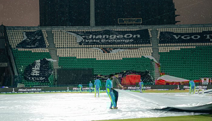 Ground staff carry covers onto the pitch at Gaddafi Stadium, Lahore, as heavy rain approaches, March 31, 2026. — X/@IsbUnited