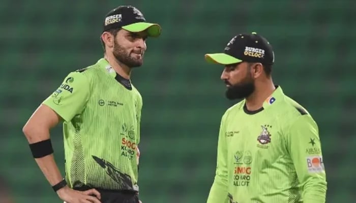 Lahore Qalandars’ captain Shaheen Shah Afridi (left) speaks with teammate Fakhar Zaman during the Pakistan Super League match between Karachi Kings and Lahore Qalandars at the Gaddafi Cricket Stadium in Lahore, March 29, 2026. — AFP