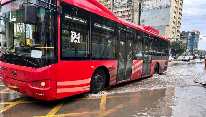 A Peoples Bus Service vehicle wades through a waterlogged road after heavy rainfall in Karachi on April 2, 2026. — Geo.tv