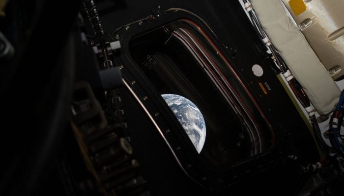 This handout picture provided by Nasa shows a view of Earth taken by NASA astronaut and Artemis II commander Reid Wiseman from one of the Orion spacecraft´s four main windows after completing the translunar injection burn on April 2, 2026. — AFP