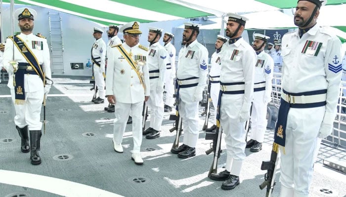 Chief of the Naval Staff Admiral Naveed Ashraf reviews the guard during the Induction Ceremony of PNS Khaibar in this image released on April 4, 2026. — ISPR