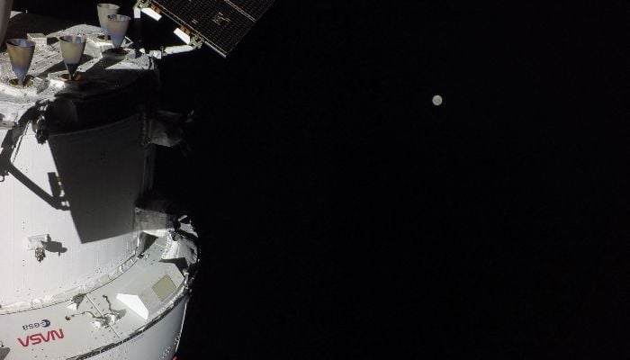 This handout picture provided by Nasa shows the Orion spacecraft with the Moon in the distance, as captured by a camera on the tip of one of its solar array wings, on April 3, 2026. — AFP
