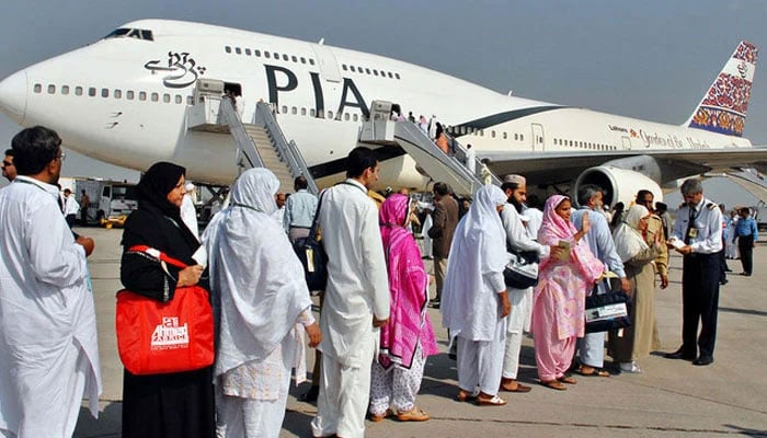 In this image, Pakistani pilgrims wait in line as they prepare to board a PIA special Hajj pilgrimage flight bound for Saudi Arabia at the Allama Iqbal International Airport in Lahore. — AFP/File