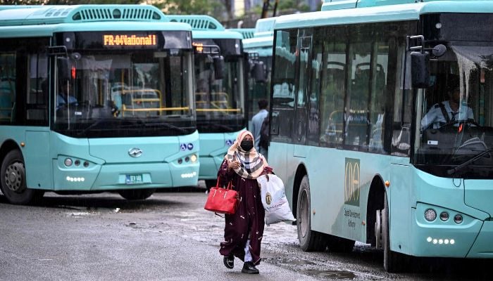 A woman passenger arrives at a government bus stop in Islamabad on April 3, 2026. — AFP