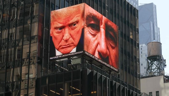 Images of US President Donald Trump and the late convicted sex offender Jeffrey Epstein are displayed on a digital billboard in Times Square in New York, April 8, 2026. — AFP