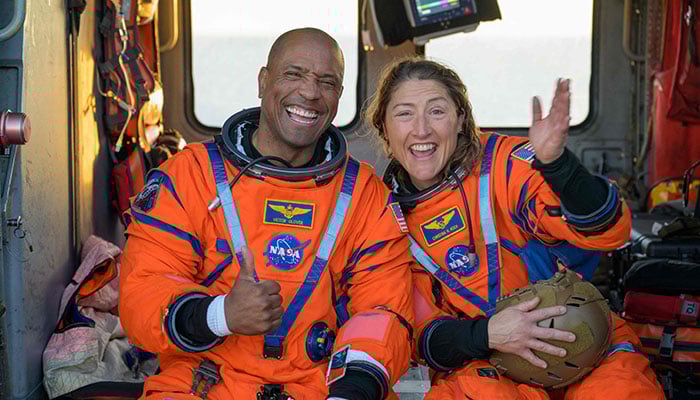 This handout photo released by Nasa shows astronaut Victor Glover (L), Artemis II pilot, and astronaut Christina Koch, Artemis II mission specialist, sitting on a Navy MH-60 Seahawk from Helicopter Sea Combat Squadron (HSC) 23 on the flight deck of USS John P Murtha after they and fellow crewmates were extracted from their Orion spacecraft after splashdown, April 10, 2026, in the Pacific Ocean off the coast of California. — AFP