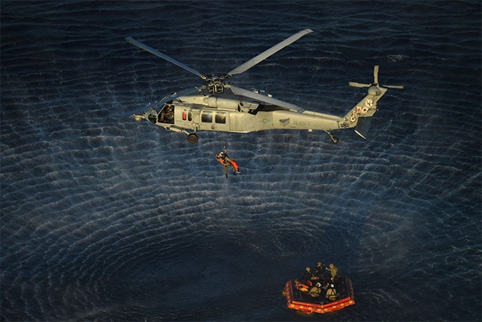 This handout photo released by Nasa shows a Nasa Artemis II crew member being hoisted into a US Navy MH-60 helicopter after successfully splashing down in the Pacific Ocean on April 10, 2026. — AFP