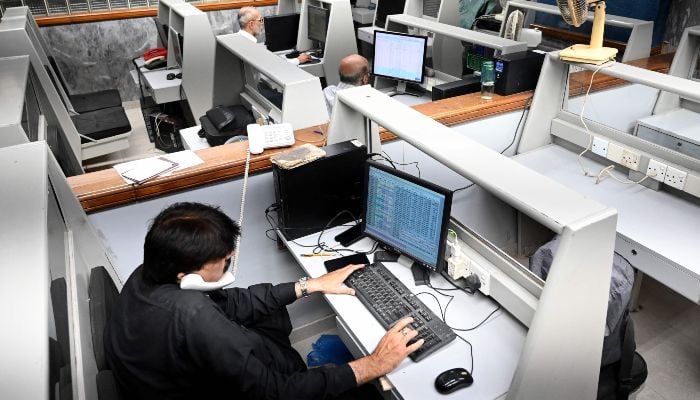 Stockbrokers monitor share prices during a trading session at the Pakistan Stock Exchange (PSX) in Karachi on April 8, 2026. — AFP