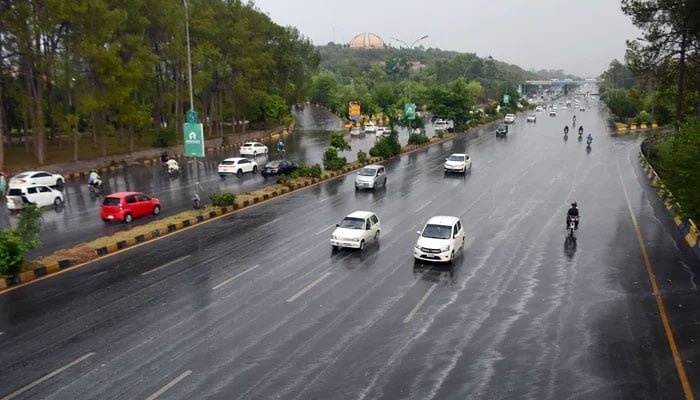 This representational image shows traffic moving through rain-soaked roads in Islamabad following heavy pre-monsoon showers on June 24, 2023. — Online