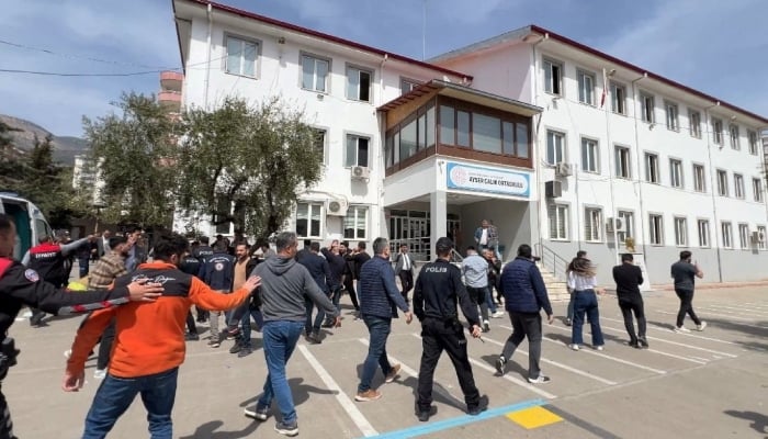 Police officers in uniform and plainclothes police secure the site after a deadly school shooting, in the southeastern province of Kahramanmaras, Turkiye, April 15, 2026. — Reuters