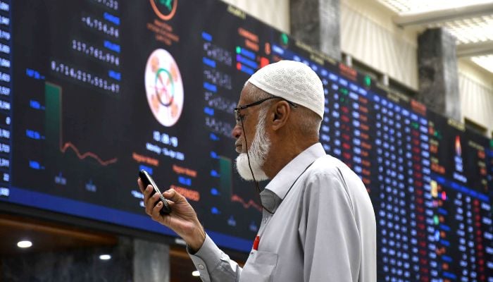 A broker monitors share prices at the Pakistan Stock Exchange (PSX) in Karachi, April 13, 2026. — Online