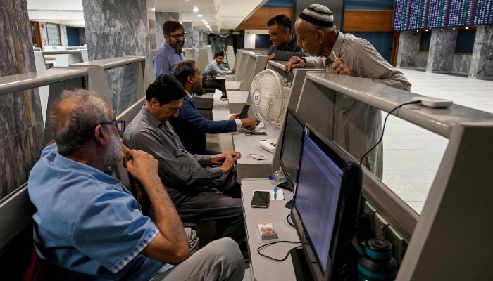 Stock brokers monitor share prices during a trading session at the Pakistan Stock Exchange (PSX) in Karachi on April 1, 2026. — AFP