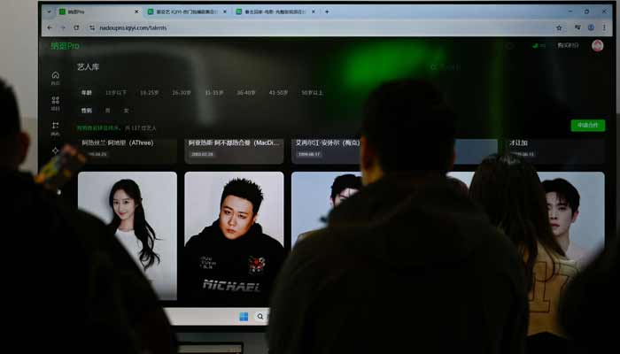 A TV screen shows iQIYI artists database on Nadou pro, iQIYI AI product for professional film and television production, during the iQIYI World Conference in Beijing on April 20, 2026.— AFP