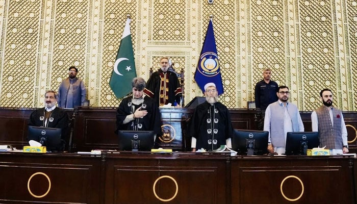 KP Assembly Speaker Babar Saleem Swati (centre) stands for national anthem before presiding over session on April 13, 2026. — Facebook/@pakpgov