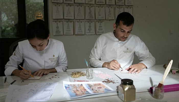 French pastry chef Bastien Blanc-Tailleur creates decorations for a wedding cake at his studio in Saint-Remy-les-Chevreuse, southwestern Paris on April 10, 2026. — AFP