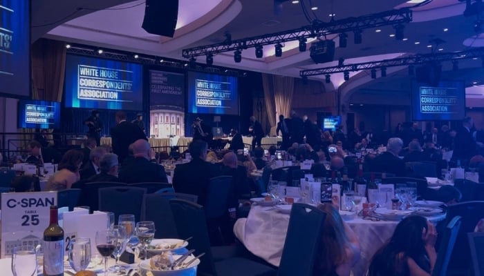 A screen grab taken from a video filmed by an AFP reporter shows armed agents moving to the stage after loud bangs were heard during the White House Correspondents´ dinner at the Washington Hilton in Washington, DC, on April 25, 2026. — AFP