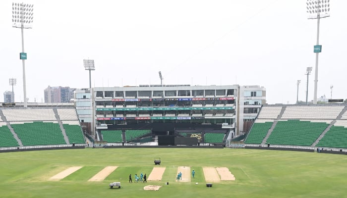 Groundsmen work on the pitch at the Gaddafi Cricket Stadium in Lahore on March 25, 2026, on the eve of the Pakistan Super League (PSL) T20 tournament opening match. — AFP